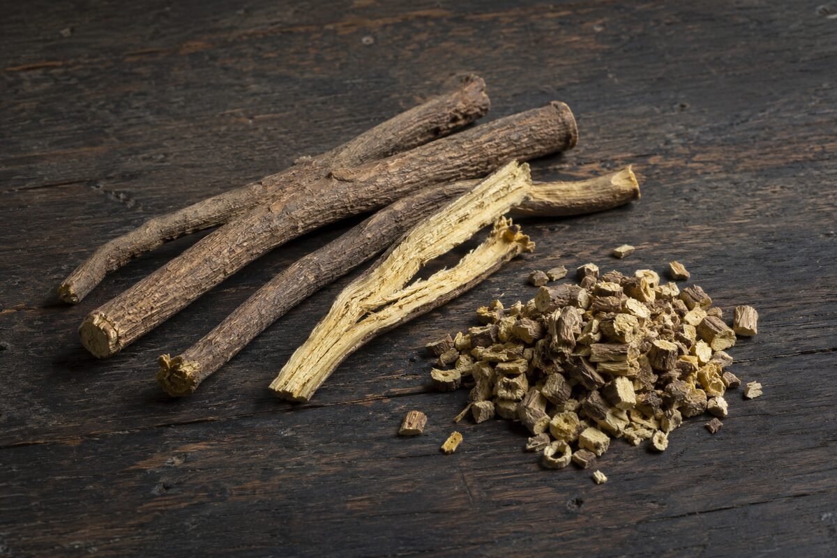 Top 10 Best Herbal Teas for Cold & Flu Season 7 Whole and chopped dried licorice root on a wooden surface