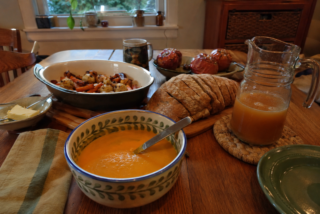 Autumn Mabon feast with squash soup, rustic bread, baked apples, and cider.